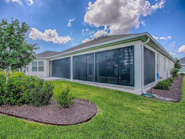 6295 Danielson Loop, The Villages, FL 32163 - back of property featuring a sunroom, a yard, and stucco siding