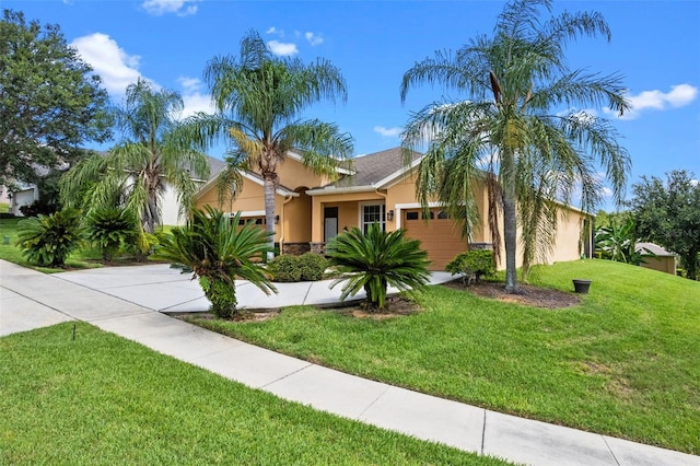 1892 Sanderling Dr, Clermont, FL 34711 - view of front of house featuring stucco siding, an attached garage, a front yard, concrete driveway, and stone siding