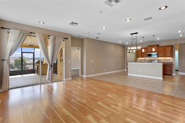 1892 Sanderling Dr, Clermont, FL 34711 - unfurnished living room featuring recessed lighting, light wood-style flooring, and ceiling fan