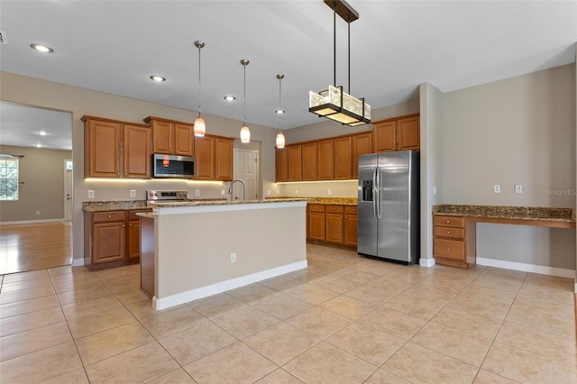 1892 Sanderling Dr, Clermont, FL 34711 - kitchen with appliances with stainless steel finishes, light tile patterned floors, brown cabinets, hanging light fixtures, and light stone countertops
