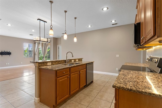 1892 Sanderling Dr, Clermont, FL 34711 - kitchen featuring electric stove, dishwasher, light tile patterned floors, brown cabinetry, and a center island with sink