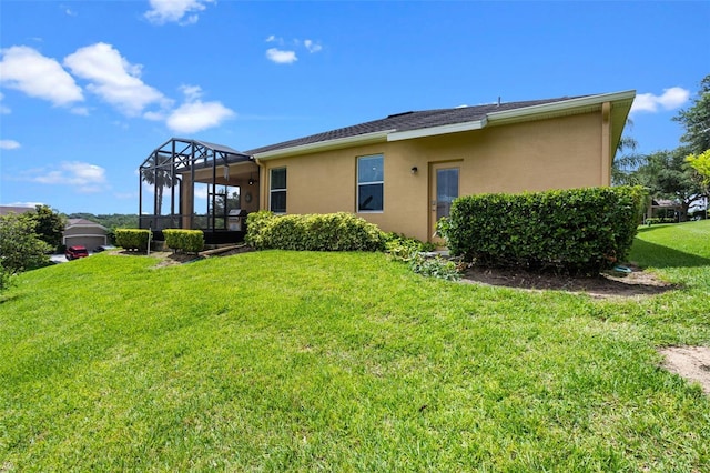 1892 Sanderling Dr, Clermont, FL 34711 - rear view of property featuring stucco siding, a lawn, and a lanai