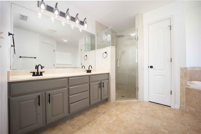 5005 County Road 125b1, Wildwood, FL 34785 - bathroom featuring double vanity, a shower stall, a garden tub, and tile patterned flooring