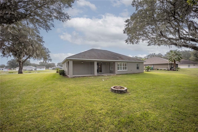 5005 County Road 125b1, Wildwood, FL 34785 - rear view of property featuring an outdoor fire pit, a yard, and a patio