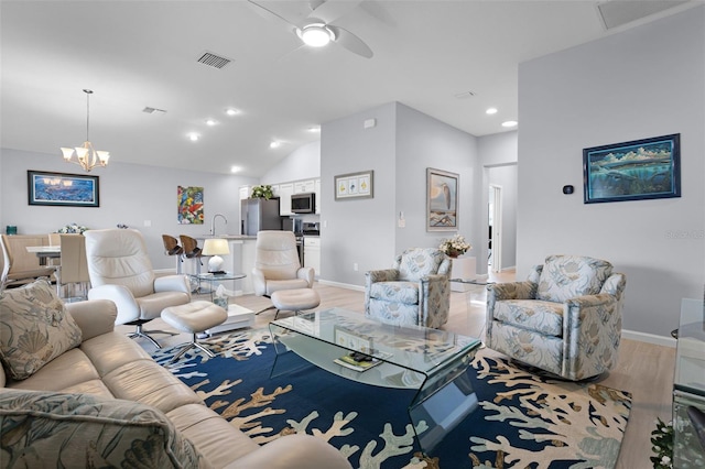5778 Henry Loop, The Villages, FL 32163 - living room with light wood-style flooring, a ceiling fan, a chandelier, lofted ceiling, and recessed lighting