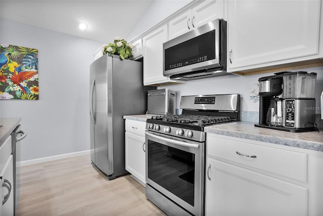 5778 Henry Loop, The Villages, FL 32163 - kitchen featuring appliances with stainless steel finishes, white cabinets, light countertops, light wood-style flooring, and recessed lighting