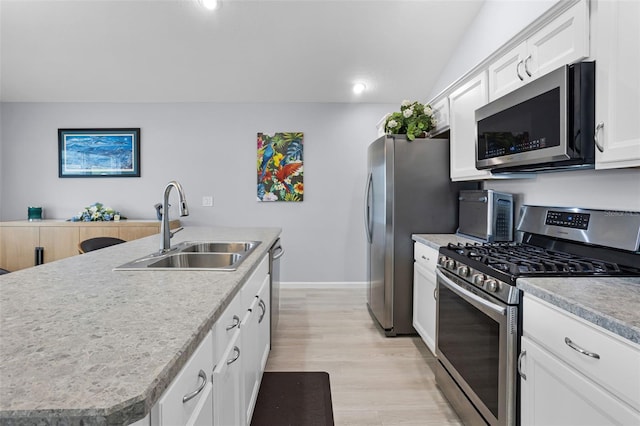 5778 Henry Loop, The Villages, FL 32163 - kitchen with stainless steel appliances, white cabinetry, a center island with sink, light countertops, and recessed lighting