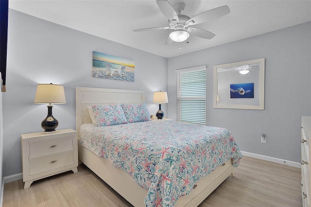 5778 Henry Loop, The Villages, FL 32163 - bedroom with light wood-style floors and a ceiling fan