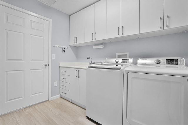5778 Henry Loop, The Villages, FL 32163 - laundry room featuring cabinet space, light wood finished floors, and independent washer and dryer