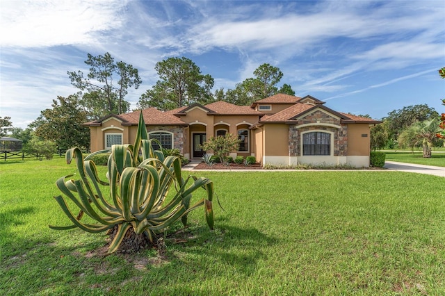 21312 Marsh View Ct, Clermont, FL 34715 - mediterranean / spanish-style home with stucco siding, stone siding, and a front lawn