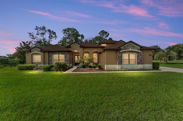 21312 Marsh View Ct, Clermont, FL 34715 - mediterranean / spanish-style home with stone siding, a yard, and stucco siding