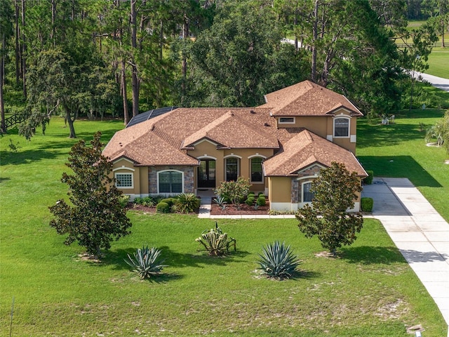 21312 Marsh View Ct, Clermont, FL 34715 - mediterranean / spanish home featuring stucco siding, a front lawn, and driveway