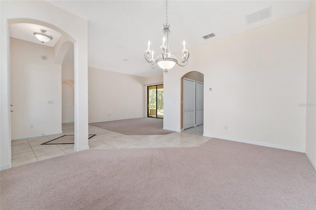 21312 Marsh View Ct, Clermont, FL 34715 - carpeted spare room with arched walkways, tile patterned flooring, and a chandelier