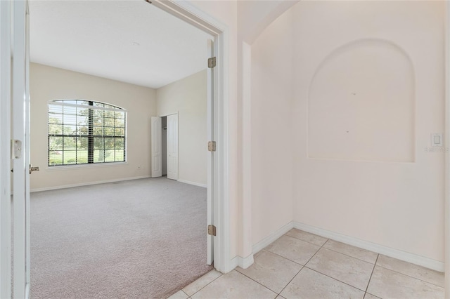21312 Marsh View Ct, Clermont, FL 34715 - empty room featuring light tile patterned flooring and light colored carpet