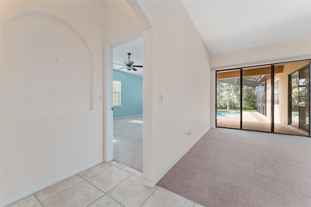 21312 Marsh View Ct, Clermont, FL 34715 - tiled empty room with arched walkways, carpet, a ceiling fan, and vaulted ceiling