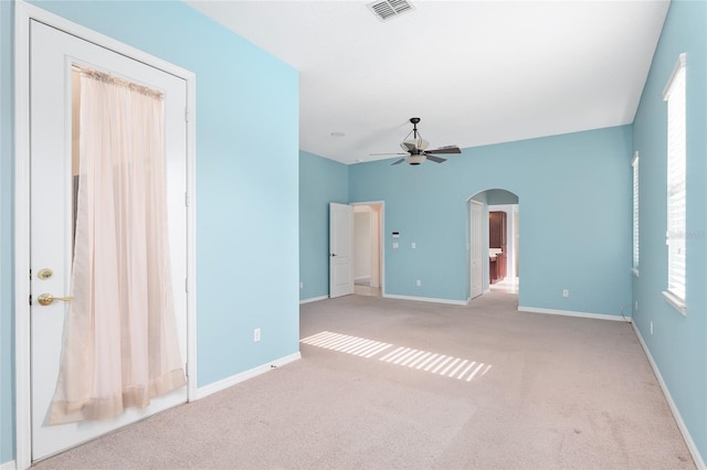 21312 Marsh View Ct, Clermont, FL 34715 - spare room featuring arched walkways, carpet, and a ceiling fan