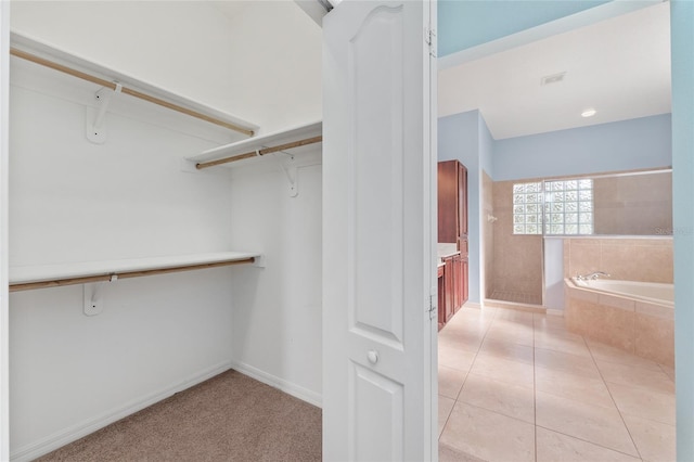 21312 Marsh View Ct, Clermont, FL 34715 - walk in closet with light tile patterned floors