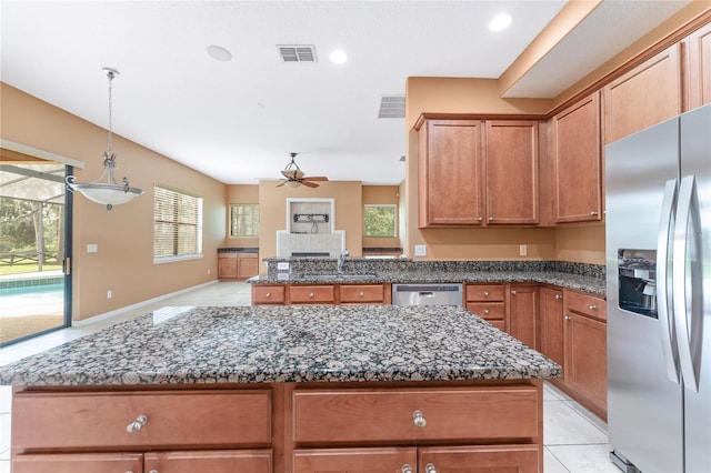 21312 Marsh View Ct, Clermont, FL 34715 - kitchen with stainless steel appliances, a ceiling fan, dark stone counters, a center island, and open floor plan