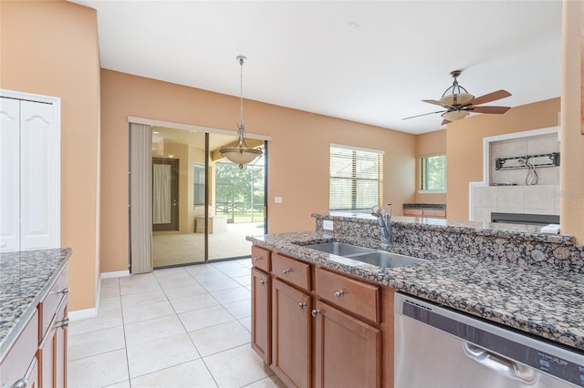 21312 Marsh View Ct, Clermont, FL 34715 - kitchen with dishwasher, dark stone countertops, hanging light fixtures, a ceiling fan, and brown cabinets