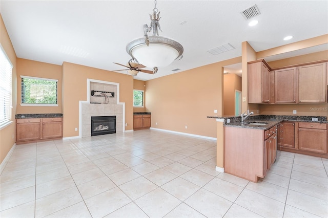 21312 Marsh View Ct, Clermont, FL 34715 - kitchen with light tile patterned floors, plenty of natural light, dark stone counters, a ceiling fan, and recessed lighting