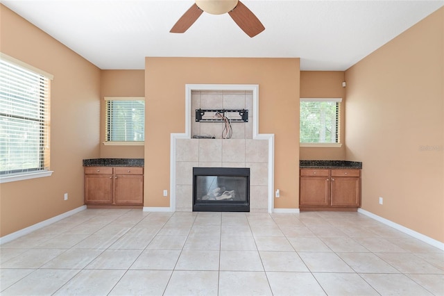 21312 Marsh View Ct, Clermont, FL 34715 - unfurnished living room with a ceiling fan, a tiled fireplace, and light tile patterned floors