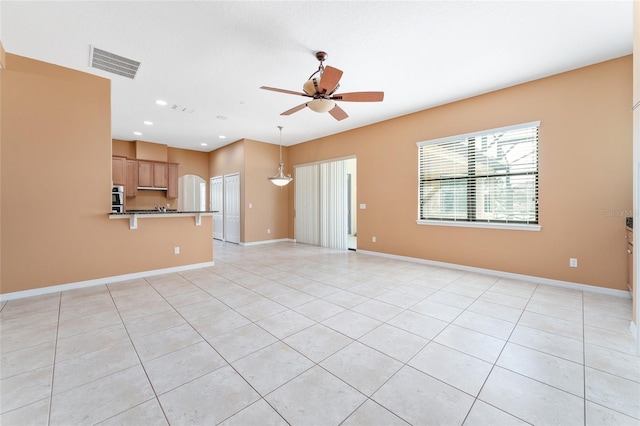 21312 Marsh View Ct, Clermont, FL 34715 - unfurnished living room featuring a ceiling fan, light tile patterned flooring, recessed lighting, and arched walkways