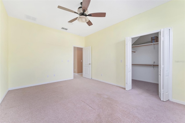 21312 Marsh View Ct, Clermont, FL 34715 - unfurnished bedroom with light colored carpet, a ceiling fan, a spacious closet, and a closet