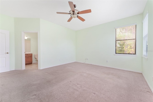 21312 Marsh View Ct, Clermont, FL 34715 - unfurnished bedroom with light colored carpet, connected bathroom, and ceiling fan