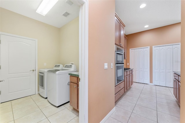 21312 Marsh View Ct, Clermont, FL 34715 - laundry area featuring washing machine and clothes dryer, light tile patterned floors, cabinet space, and recessed lighting