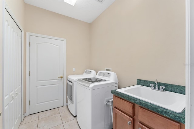 21312 Marsh View Ct, Clermont, FL 34715 - laundry area featuring washer and clothes dryer, cabinet space, and light tile patterned floors