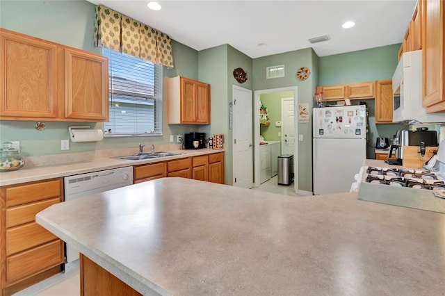 3507 Arlington Ridge Blvd, Leesburg, FL 34748 - kitchen with white appliances, washing machine and dryer, light countertops, a peninsula, and recessed lighting