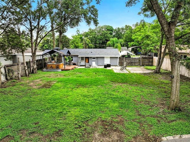 1610 Williams Ave, Eustis, FL 32726 - rear view of property with a fenced backyard, a wooden deck, and a patio