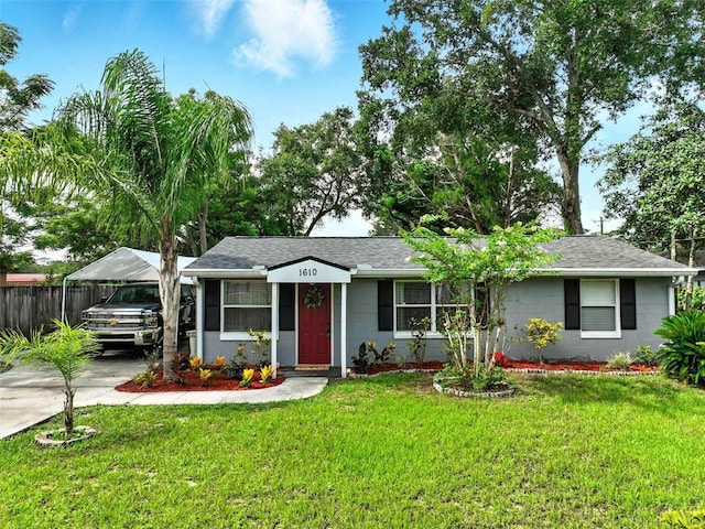 1610 Williams Ave, Eustis, FL 32726 - ranch-style house featuring a carport, concrete block siding, roof with shingles, and concrete driveway