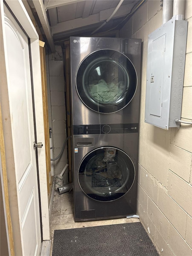 1610 Williams Ave, Eustis, FL 32726 - laundry room with estacked washer and dryer, electric panel, and concrete block wall