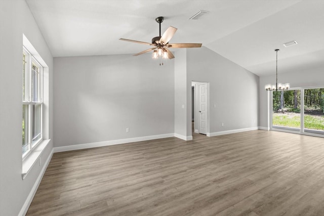 8641 N Stern Way, Citrus Springs, FL 34434 - unfurnished living room with vaulted ceiling, a chandelier, ceiling fan, and wood finished floors