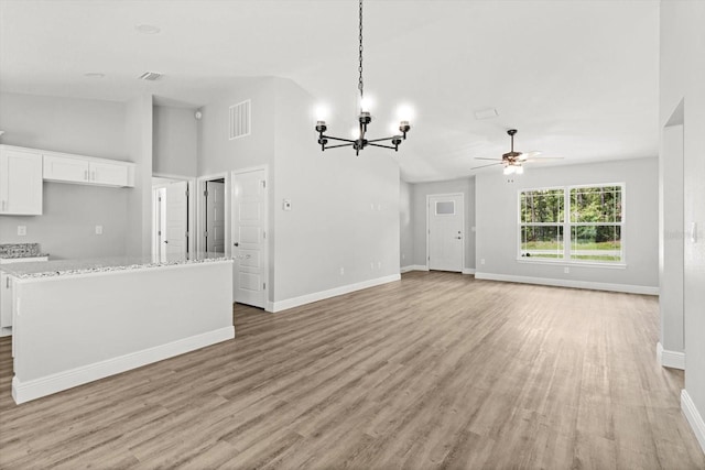 8641 N Stern Way, Citrus Springs, FL 34434 - unfurnished living room with light wood-style flooring, a chandelier, ceiling fan, and a high ceiling