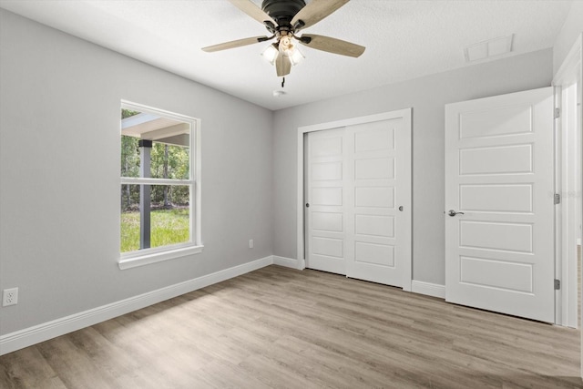 8641 N Stern Way, Citrus Springs, FL 34434 - unfurnished bedroom featuring wood finished floors, a closet, and a ceiling fan