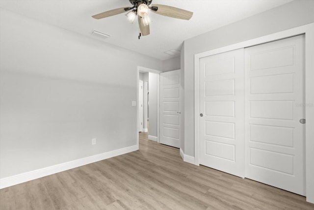 8641 N Stern Way, Citrus Springs, FL 34434 - unfurnished bedroom featuring light wood-type flooring, a closet, and ceiling fan