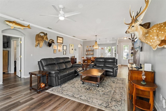 5971 Brittania Blvd, Tavares, FL 32778 - living area featuring arched walkways, wood finished floors, a ceiling fan, and crown molding