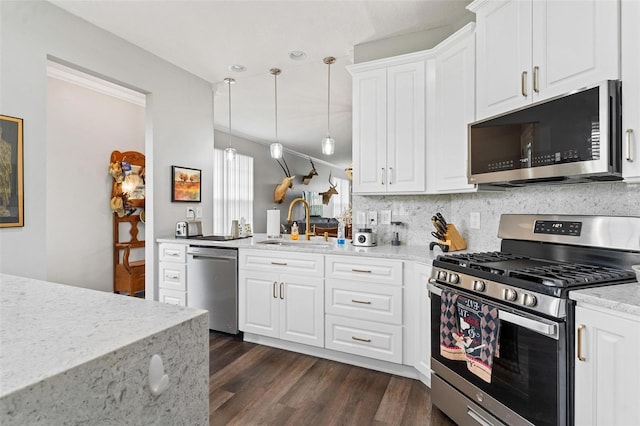 5971 Brittania Blvd, Tavares, FL 32778 - kitchen with appliances with stainless steel finishes, light stone countertops, pendant lighting, and white cabinets