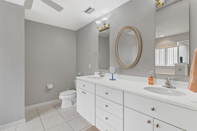 5971 Brittania Blvd, Tavares, FL 32778 - bathroom with double vanity, tile patterned floors, ceiling fan, and a textured ceiling
