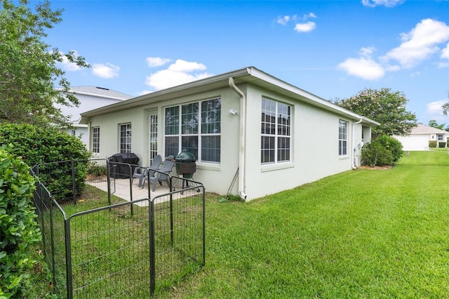 5971 Brittania Blvd, Tavares, FL 32778 - rear view of house featuring stucco siding and a patio area