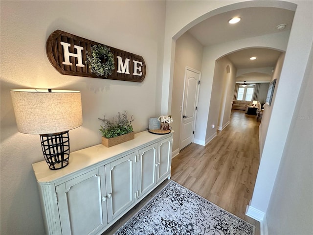 384 Summer Squall Rd, Davenport, FL 33837 - corridor with arched walkways, light wood finished floors, and recessed lighting