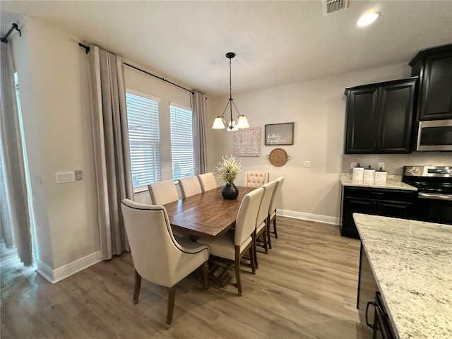 384 Summer Squall Rd, Davenport, FL 33837 - dining space with baseboards and light wood finished floors