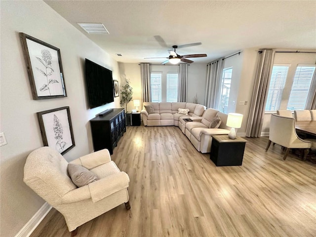 384 Summer Squall Rd, Davenport, FL 33837 - living room featuring light wood finished floors and a ceiling fan