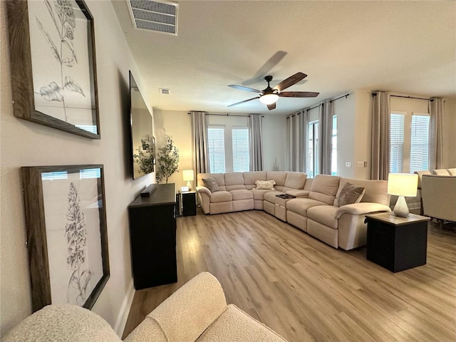 384 Summer Squall Rd, Davenport, FL 33837 - living area featuring a ceiling fan and light wood-style flooring