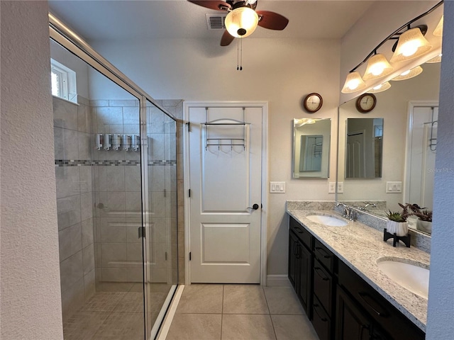 384 Summer Squall Rd, Davenport, FL 33837 - bathroom featuring double vanity, tile patterned floors, a stall shower, and a ceiling fan