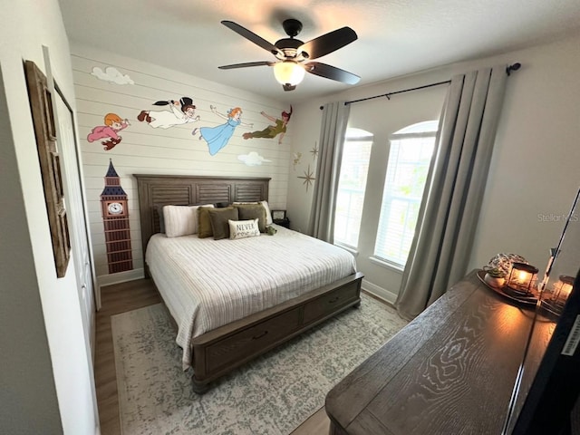 384 Summer Squall Rd, Davenport, FL 33837 - bedroom with wood finished floors, a ceiling fan, and wooden walls
