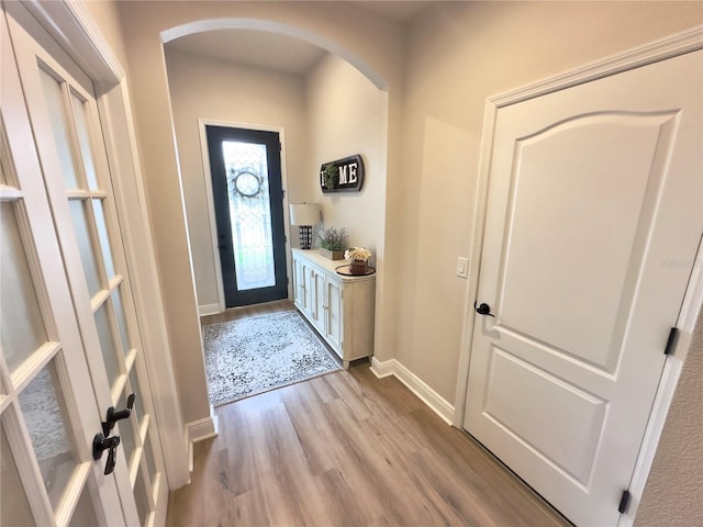 384 Summer Squall Rd, Davenport, FL 33837 - foyer with arched walkways and light wood-type flooring