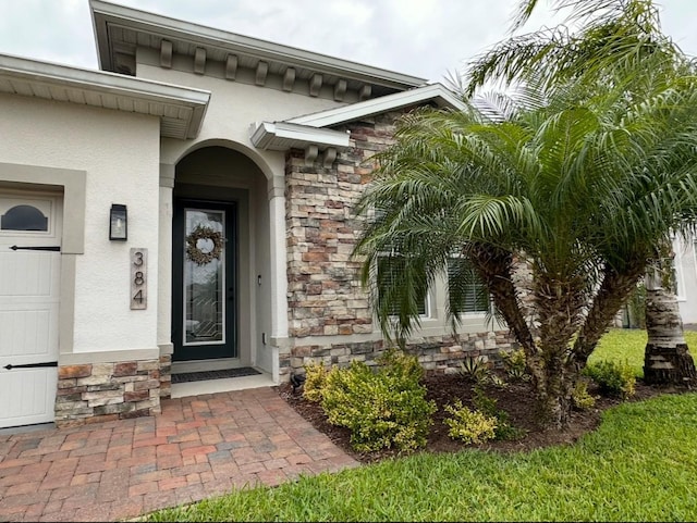 384 Summer Squall Rd, Davenport, FL 33837 - view of exterior entry with stone siding and stucco siding